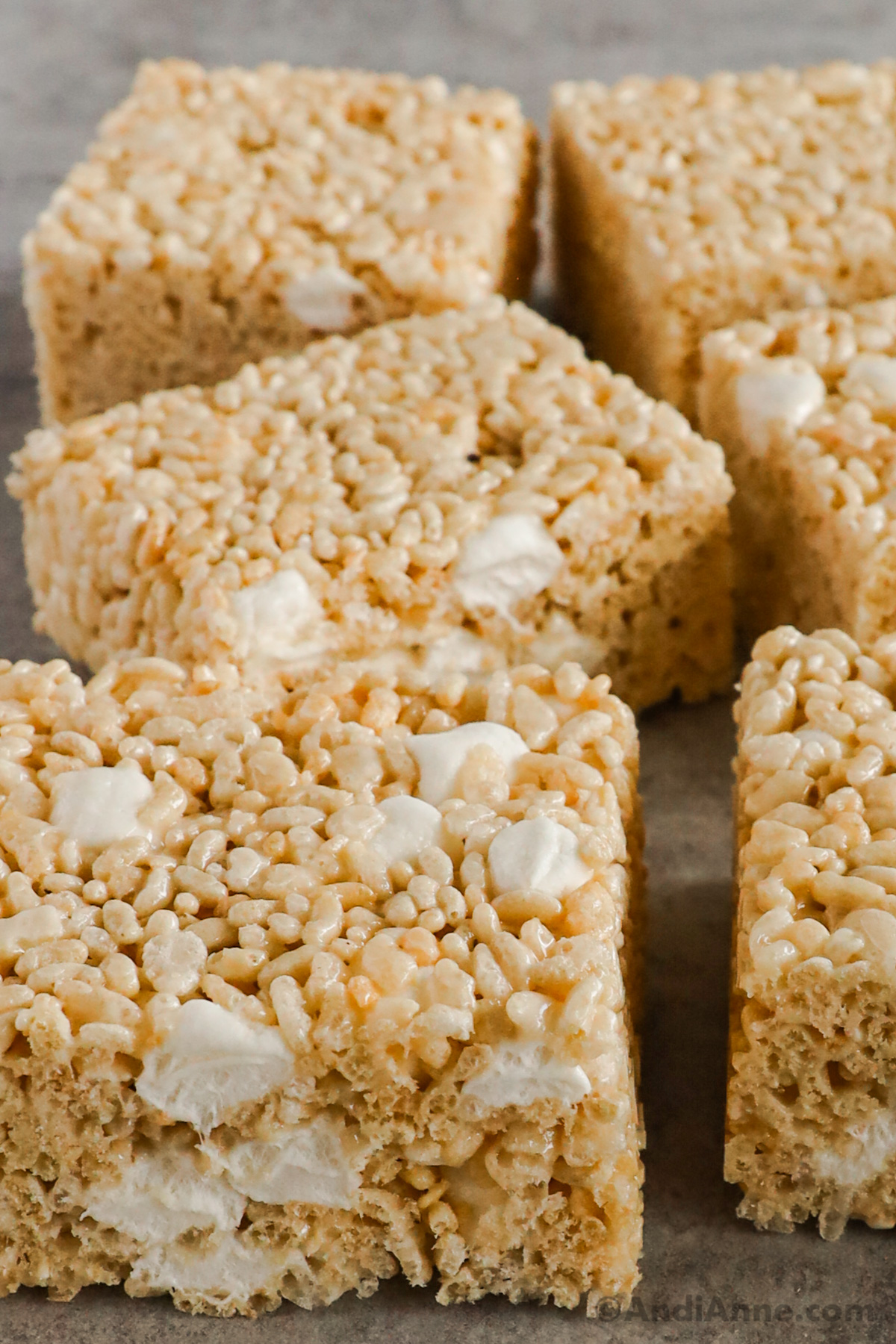 Close up of rice krispie squares with mini marshmallows inside.