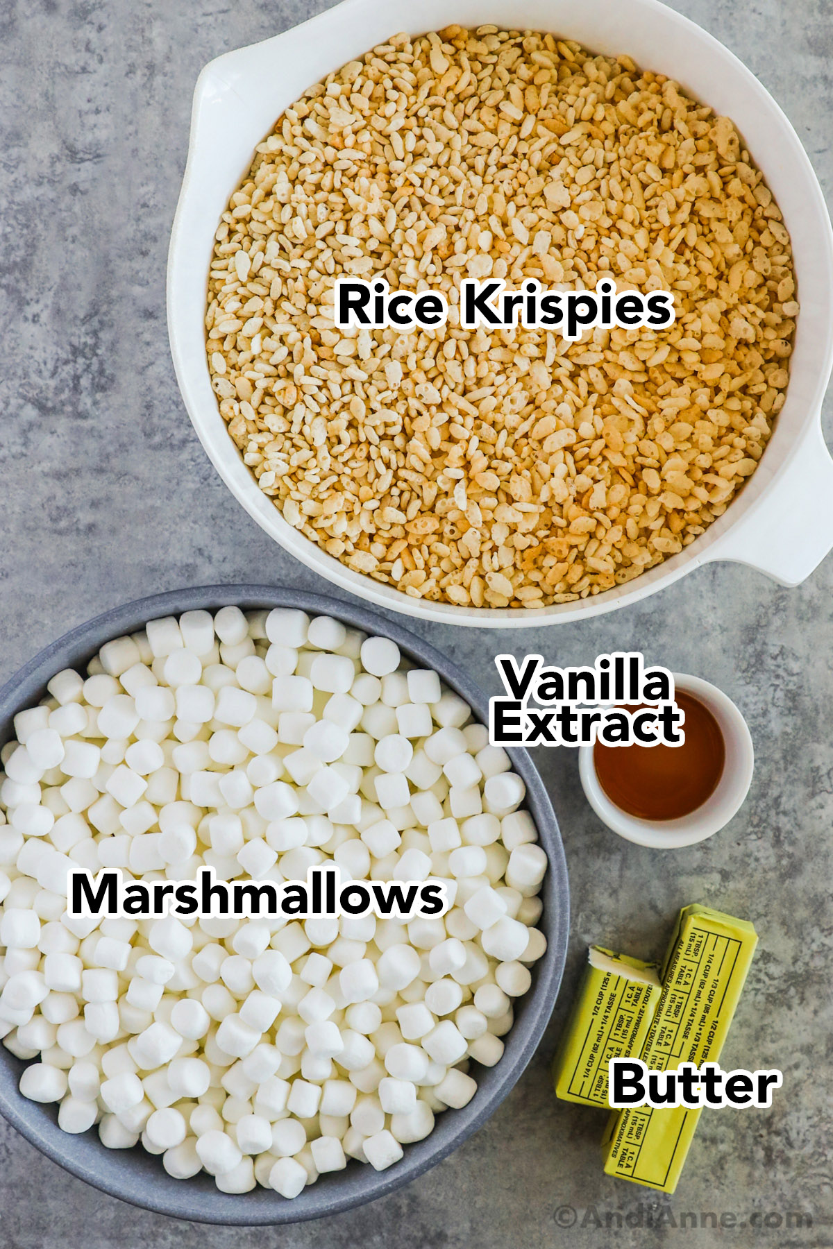 A bowl of rice krispies, bowl of mini marshmallows, vanilla extract, and butter.