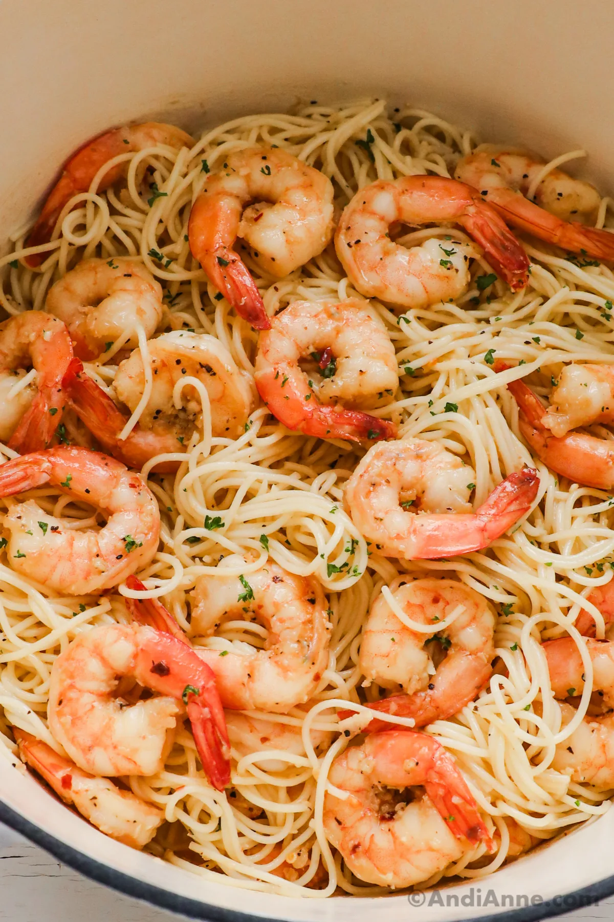 Close up of pasta and shrimp in a pot.