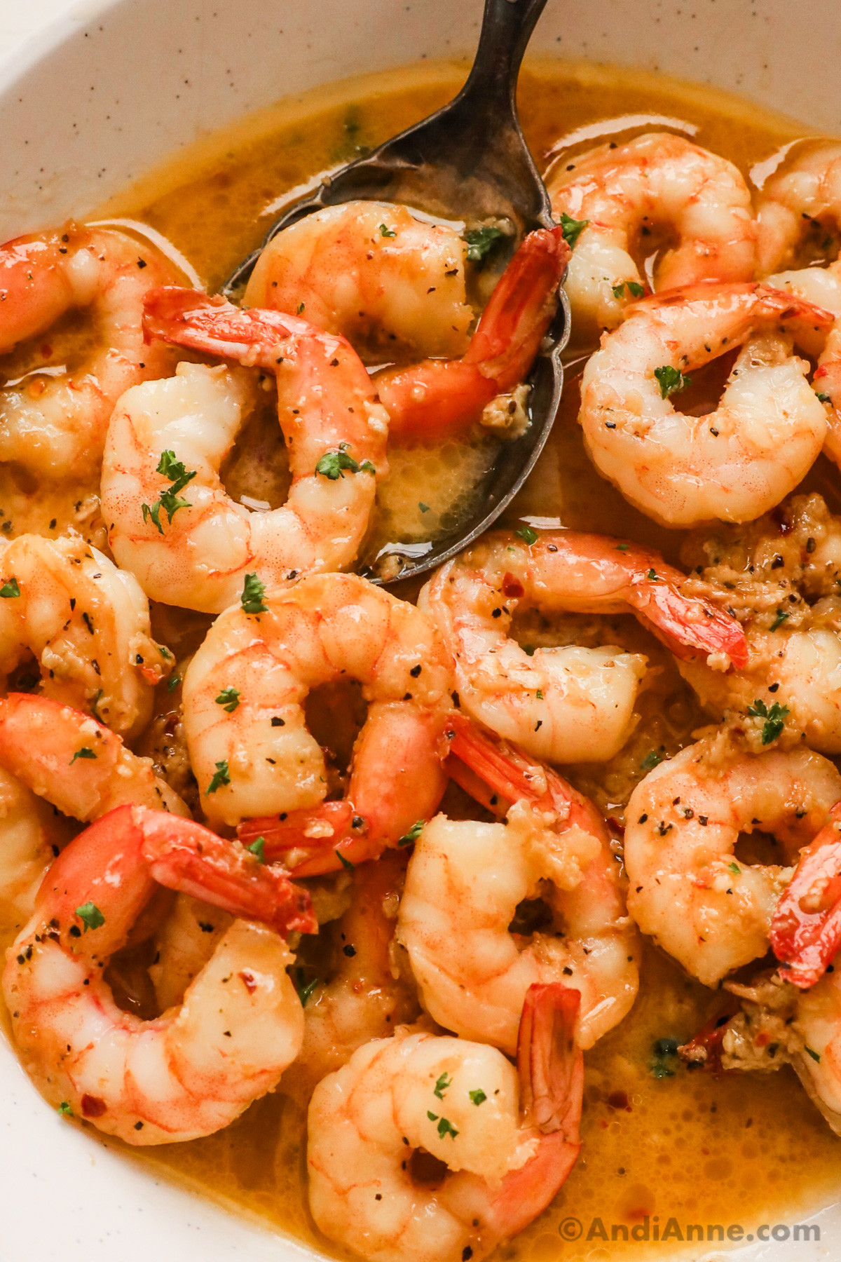 Close up of cooked shrimp in a garlic butter sauce.