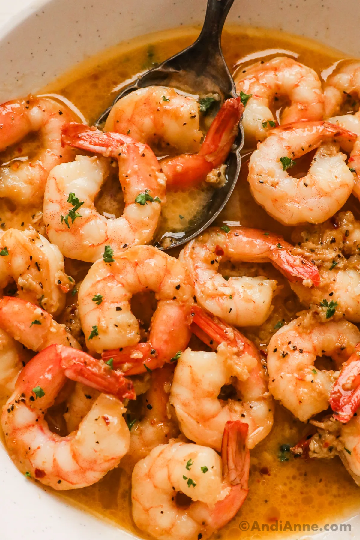 Close up of cooked shrimp in a garlic butter sauce.