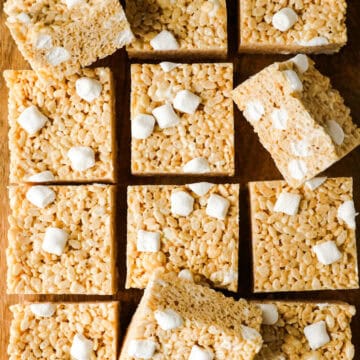 rice krispie squares with extra marshmallows on a cutting board