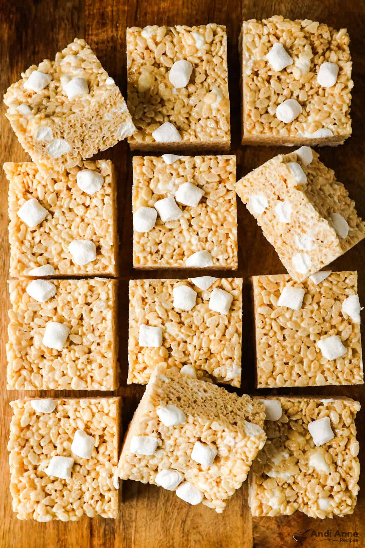 rice krispie squares with extra marshmallows on a cutting board