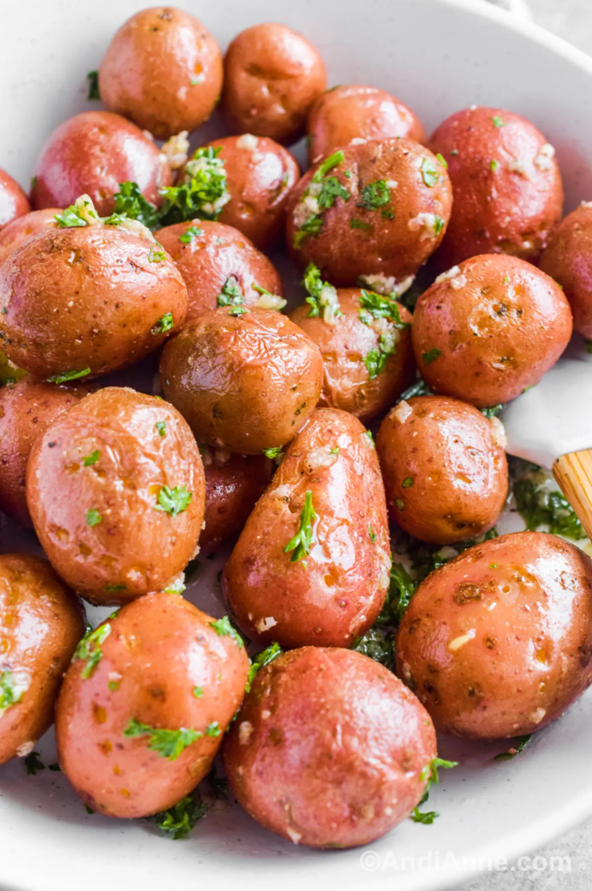 Closeup of cooked mini potatoes with dressing. 