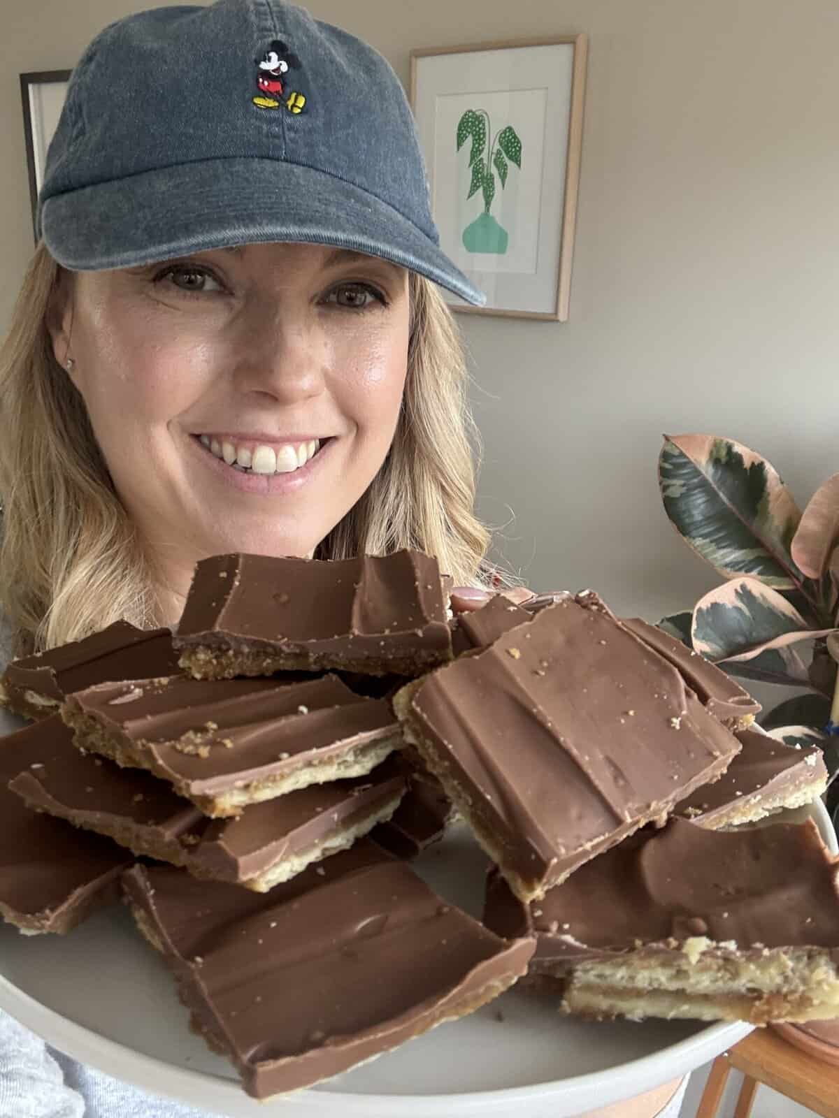 Andi holding a plate of holiday cracker candy