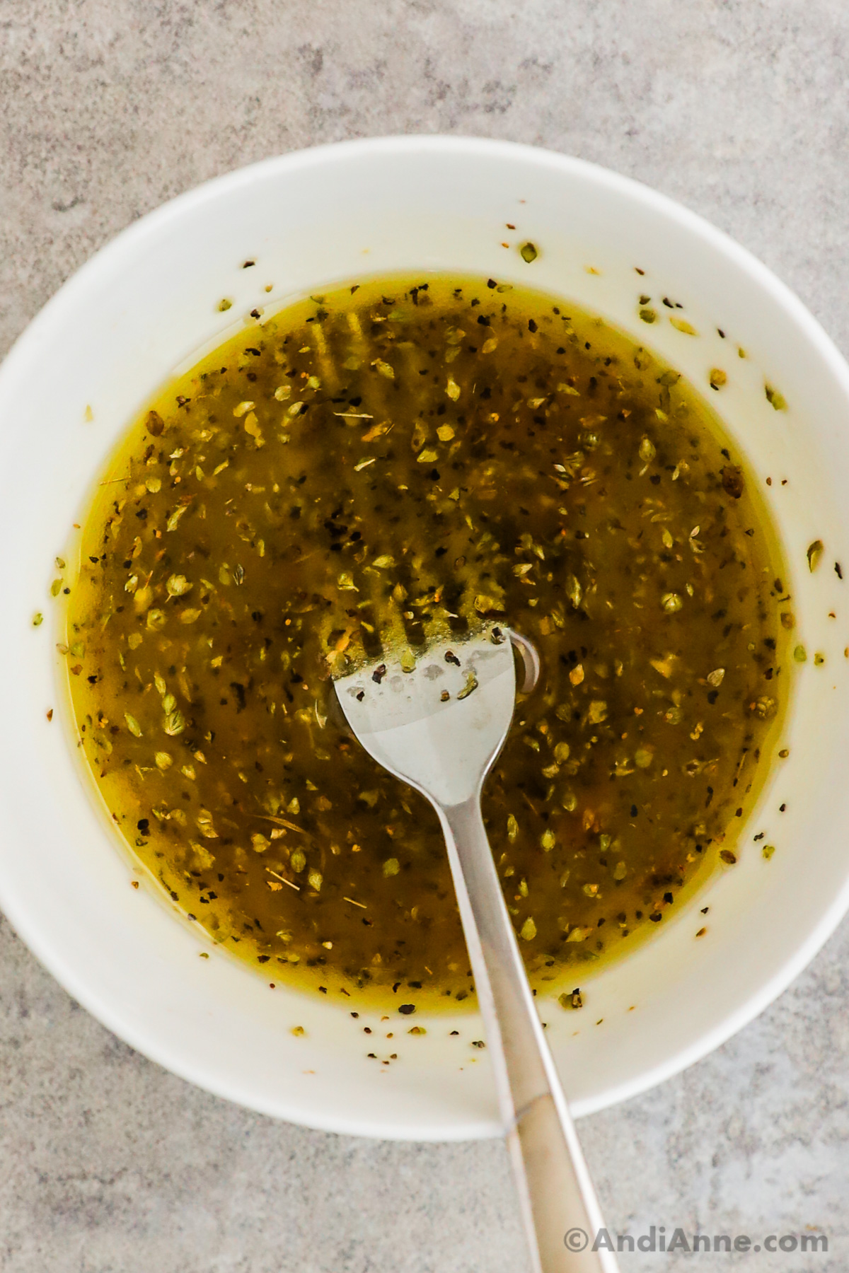 Bowl of salad dressing with a fork