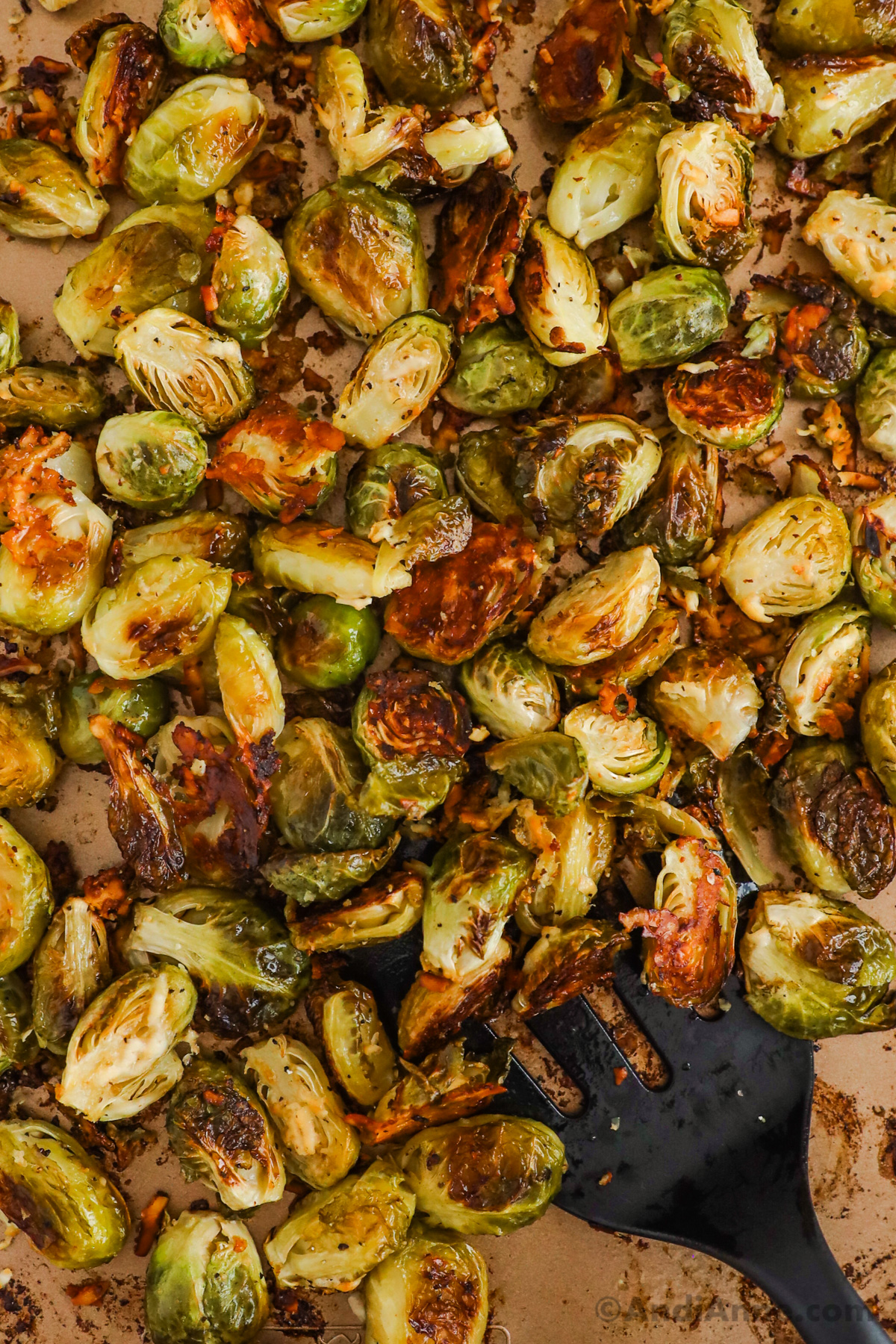 Close up of crispy garlic parmesan brussels sprouts on a baking sheet