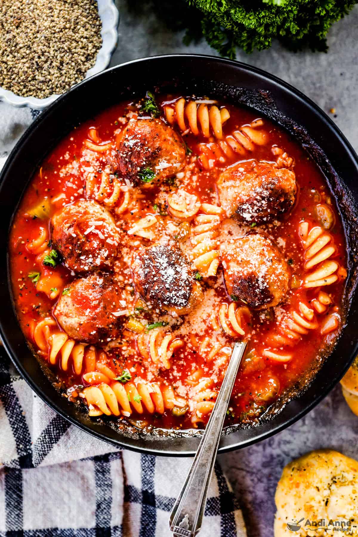 Black bowl of italian sausage meatball soup