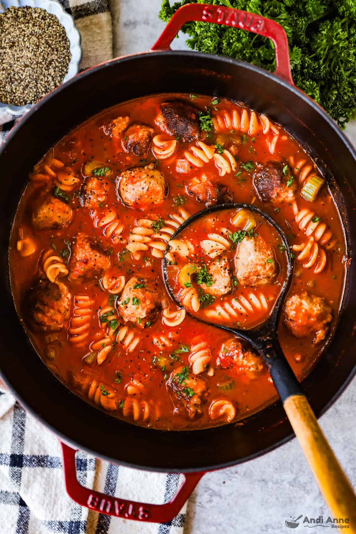 Pot of italian meatball soup with soup ladle