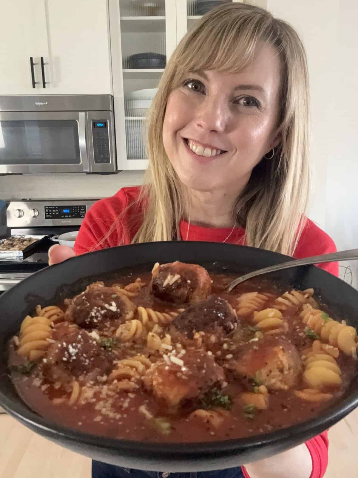 Andi holding a bowl of italian meatball soup