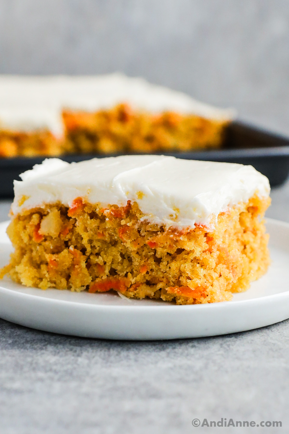 Close up of a slice of carrot cake with cream cheese icing