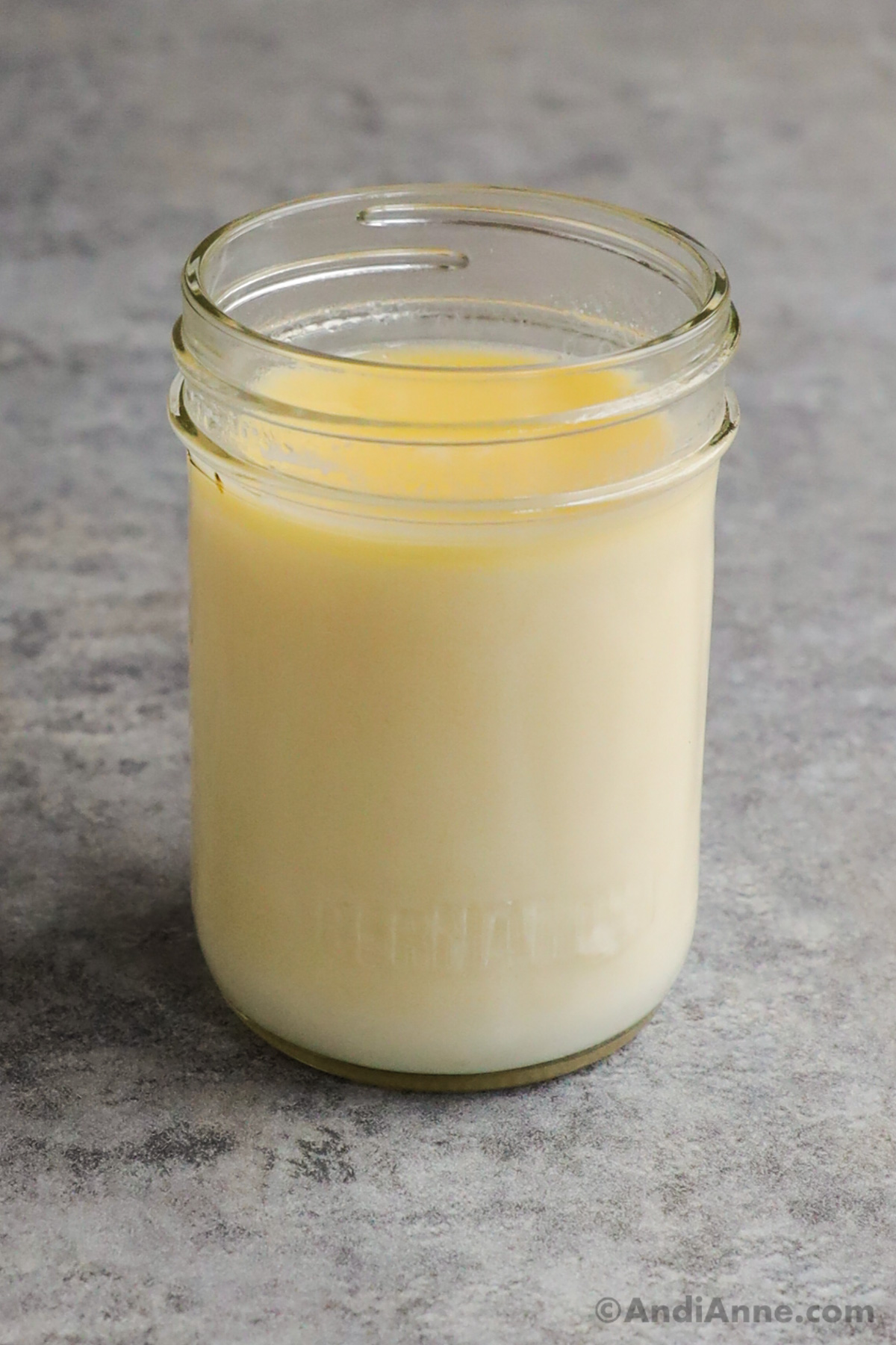 A mason jar of homemade heavy cream.