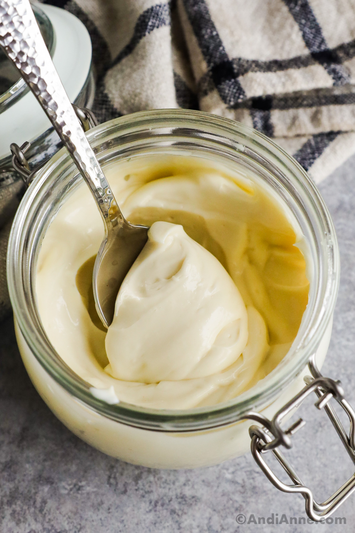 A jar of homemade mayonnaise with a spoon