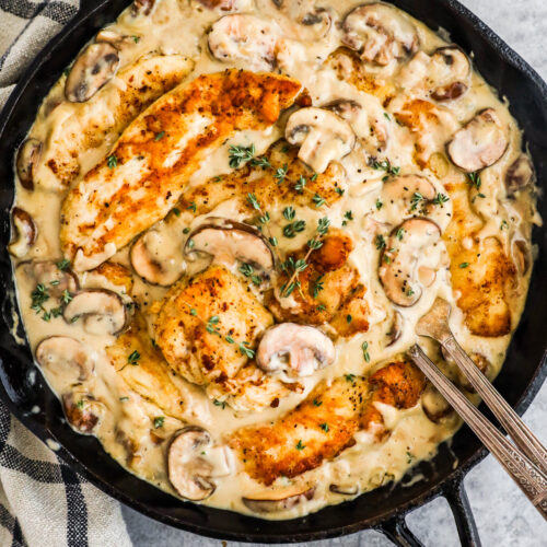 A pan with chicken in creamy mushroom sauce