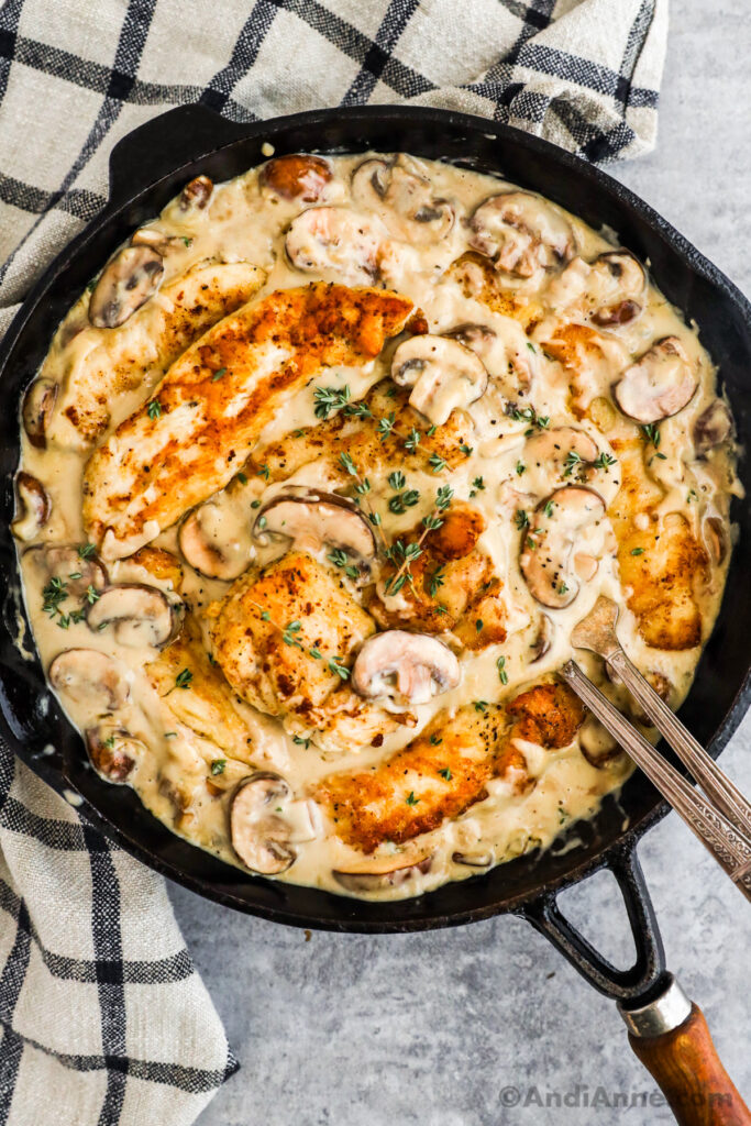 A pan with chicken in creamy mushroom sauce