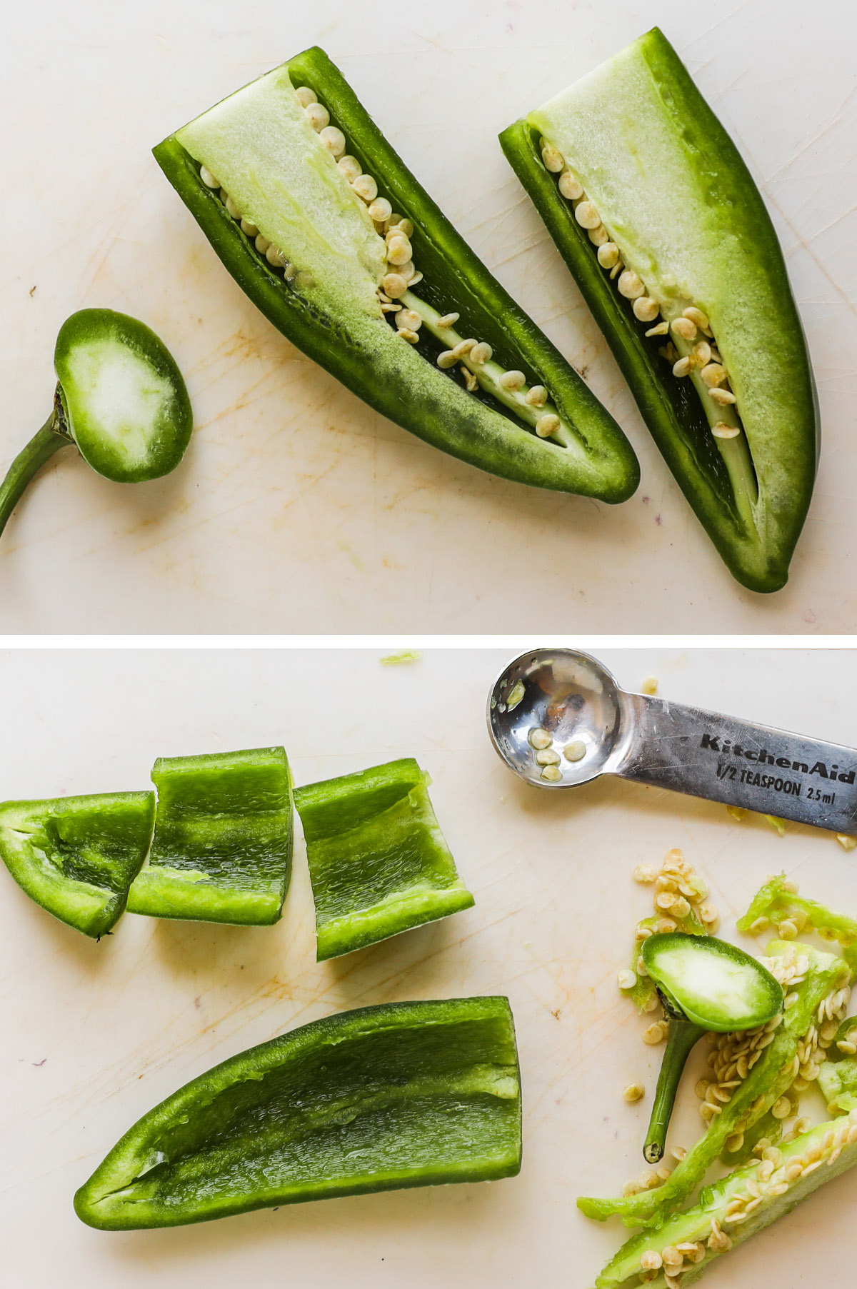 A jalapeno first cut in half, then the inner rib and seeds scraped out with a spoon.