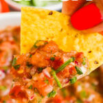 Close up of a tortilla chip with 5 minute restaurant style salsa recipe