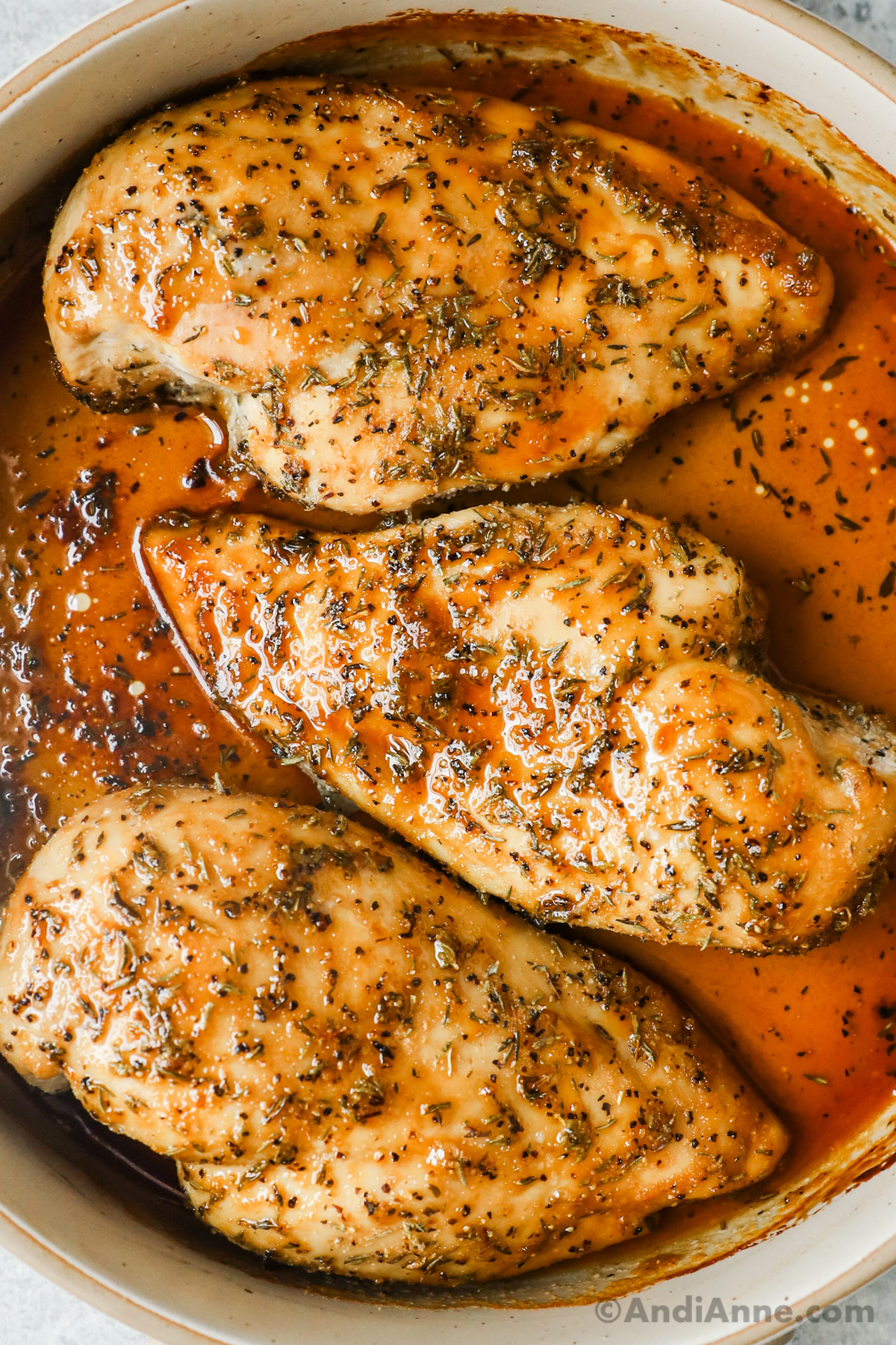 Close up of three cooked chicken breasts covered in a glossy brown sugar sauce.