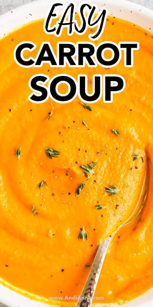 Close up of a bowl of creamy carrot soup with a spoon