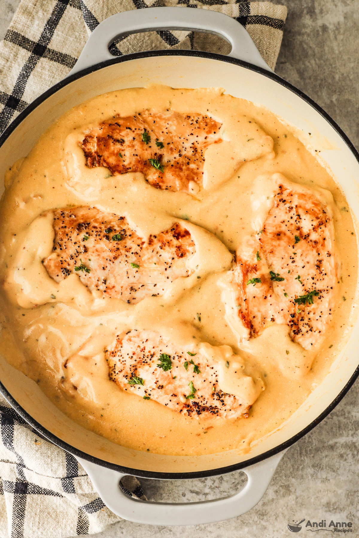 Four cooked chicken breasts in a creamy sauce for ranch chicken recipe