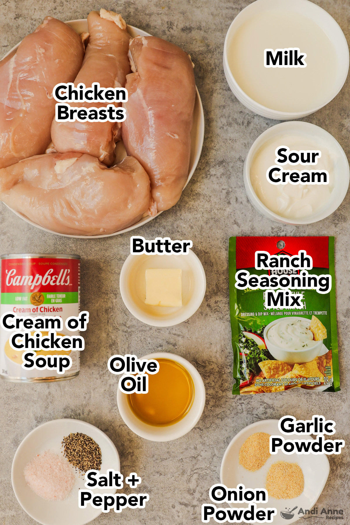 Raw chicken breasts, bowls of milk, sour cream, butter, oil, spices, a cream of chicken canned soup, and packet of ranch mix.