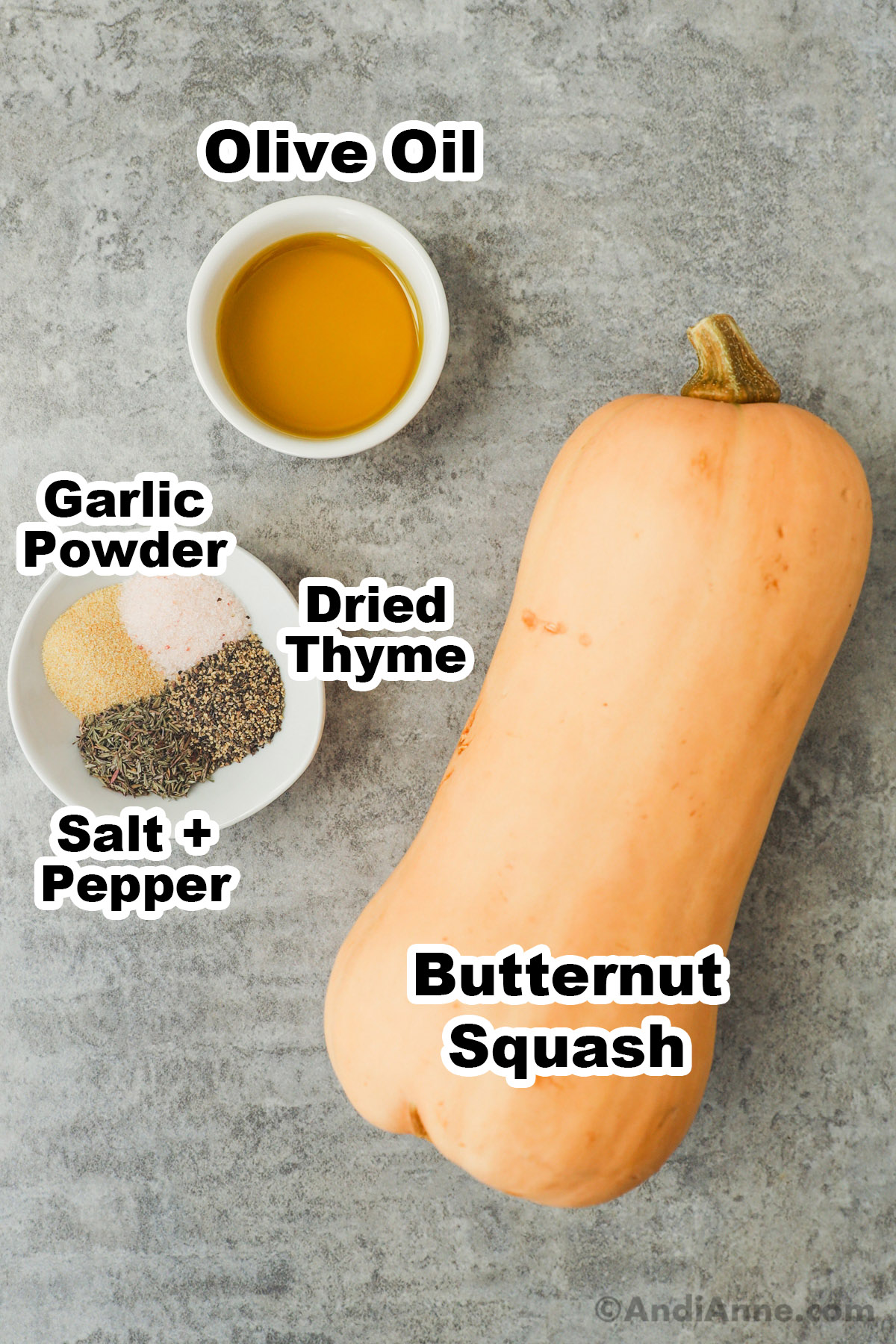 A butternut squash, bowl of olive oil, and bowl with spices.