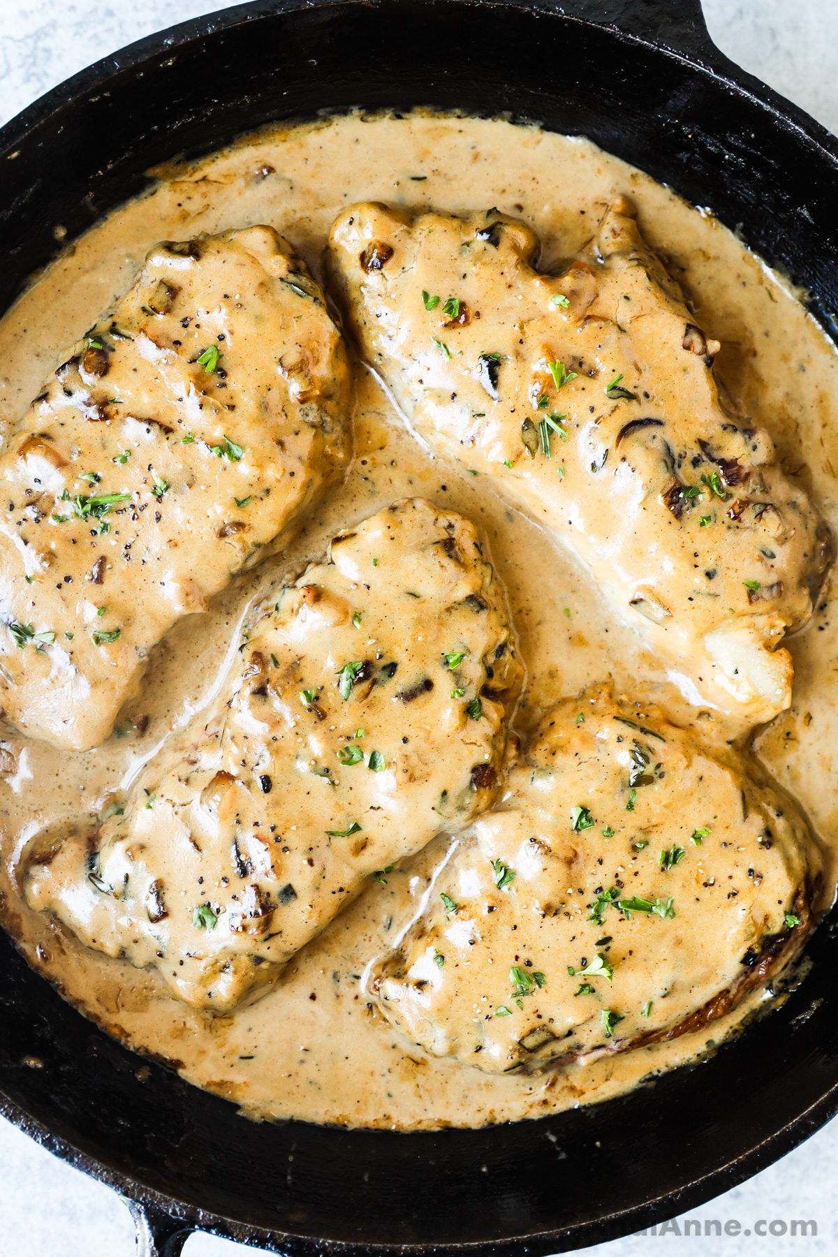 Close up of pork chops smothered in gravy.