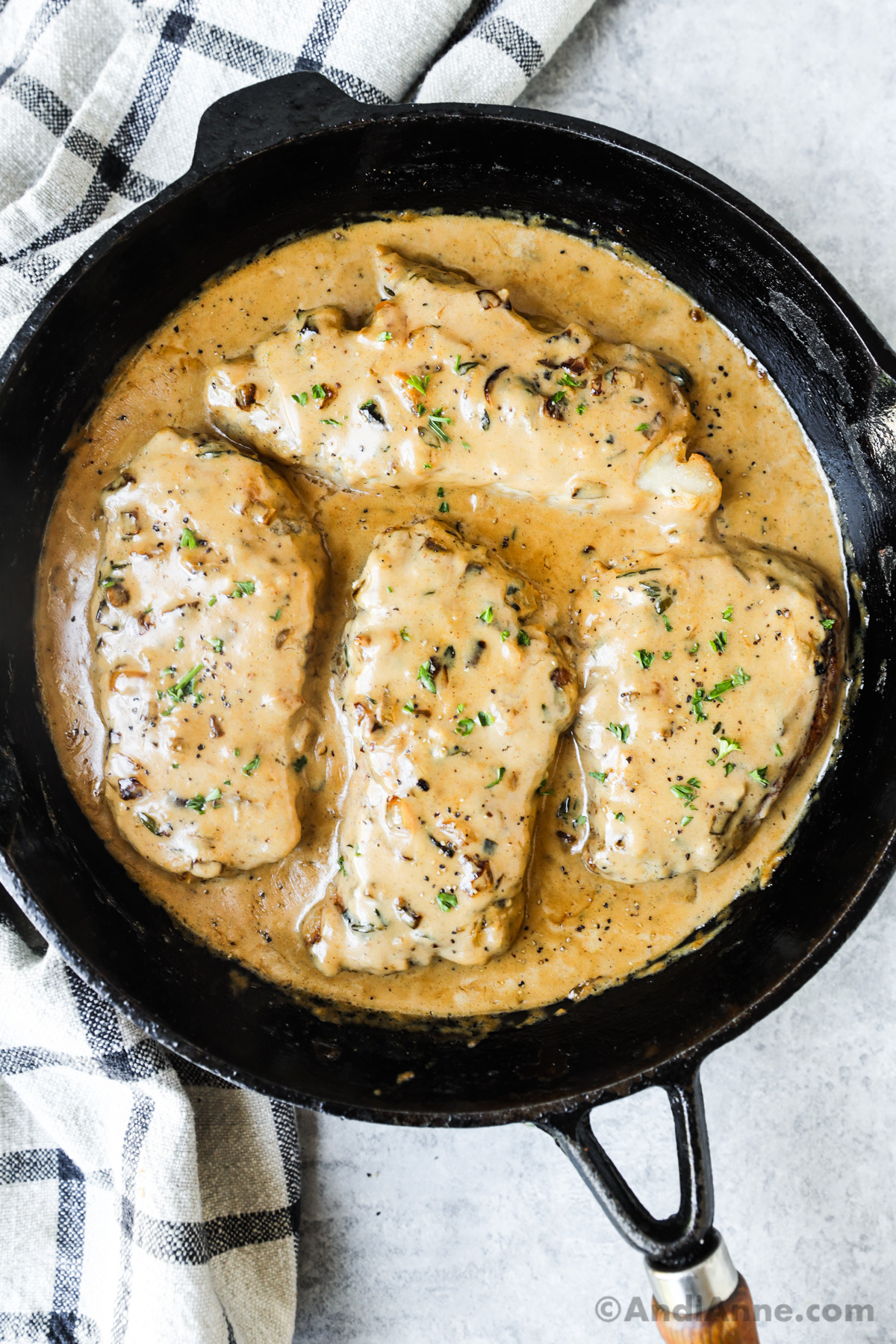 A pan with pork chops smothered in gravy. 