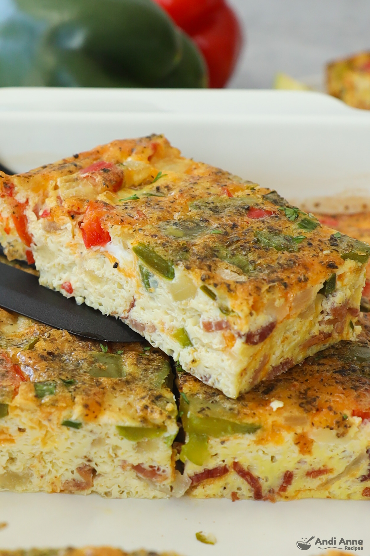 Slices of egg casserole with chopped vegetables. 