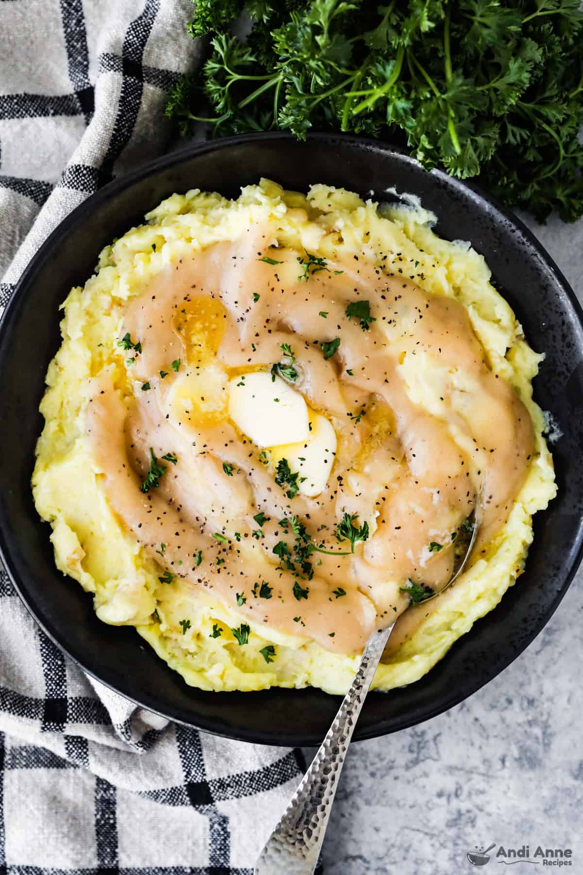Garlic mashed potatoes topped with homemade brown gravy and butter