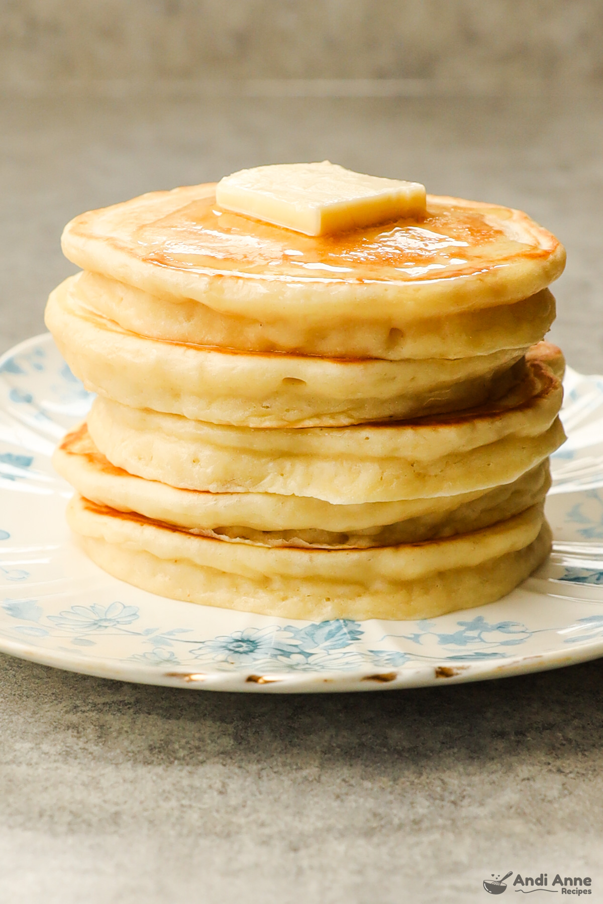 A stack of greek yogurt pancakes with butter.