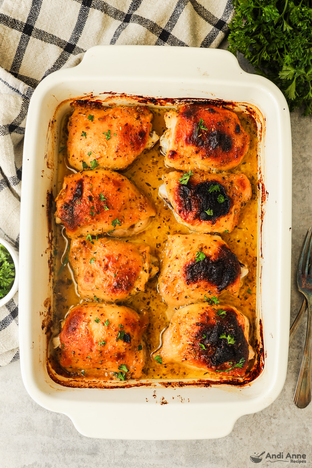 White casserole dish with honey mustard chicken thighs 