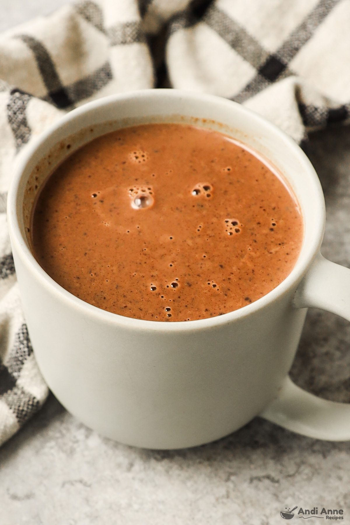 A mug of creamy hot chocolate.