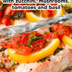 Close up of easy salmon foil packed dinner with zucchini, mushrooms, tomatoes and basil