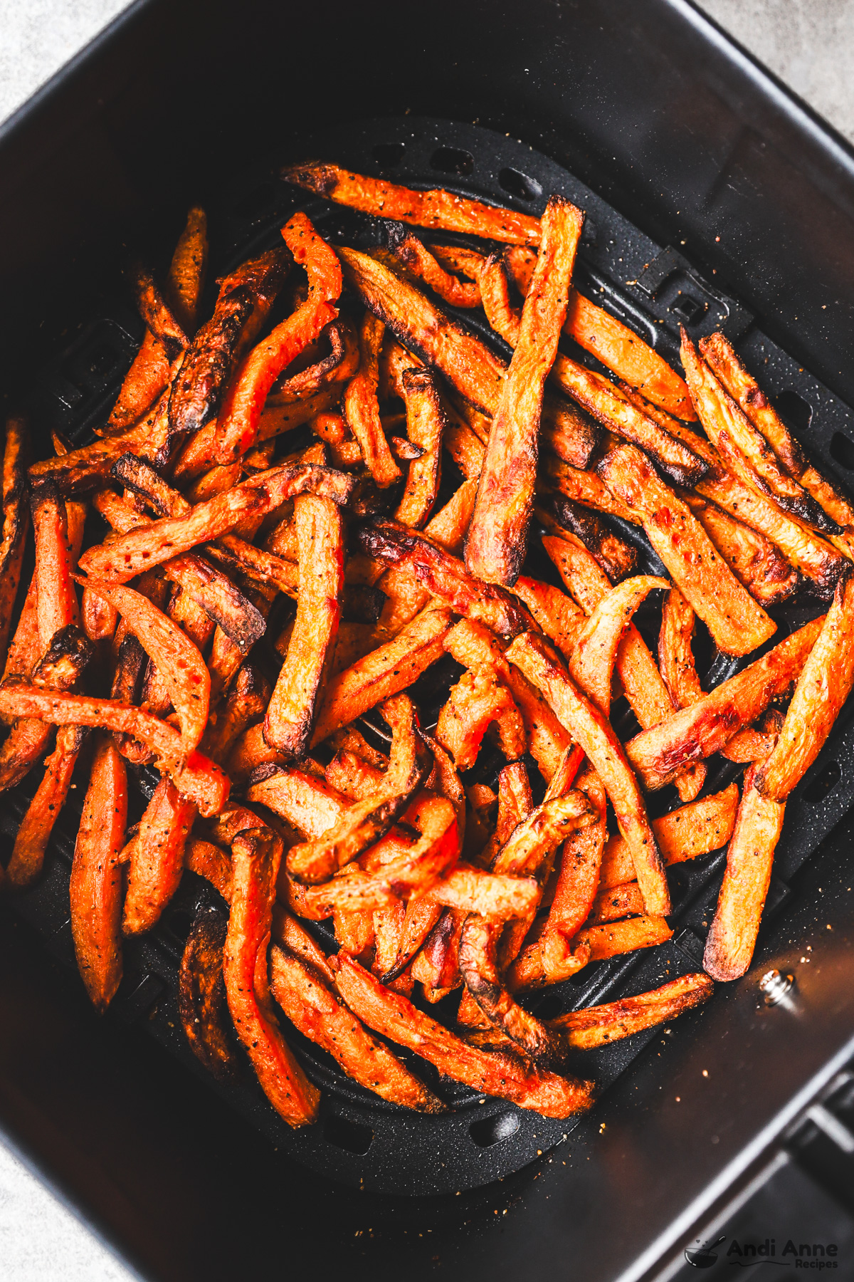 A basket with cooked air fryer sweet potato fries