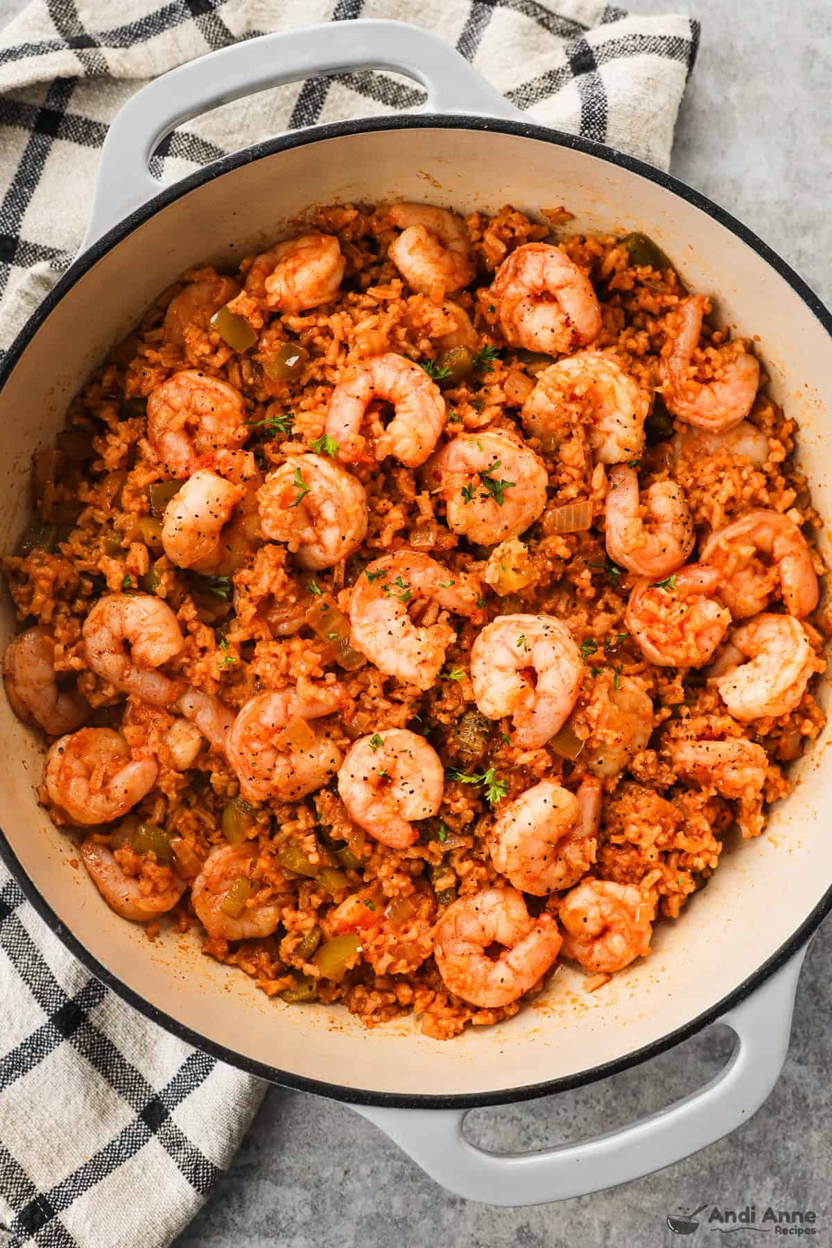 A pot with rice and shrimp in a golden hue