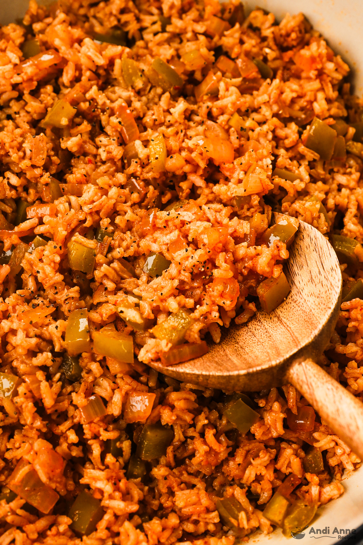 close up of cajun rice recipe with a wood spoon