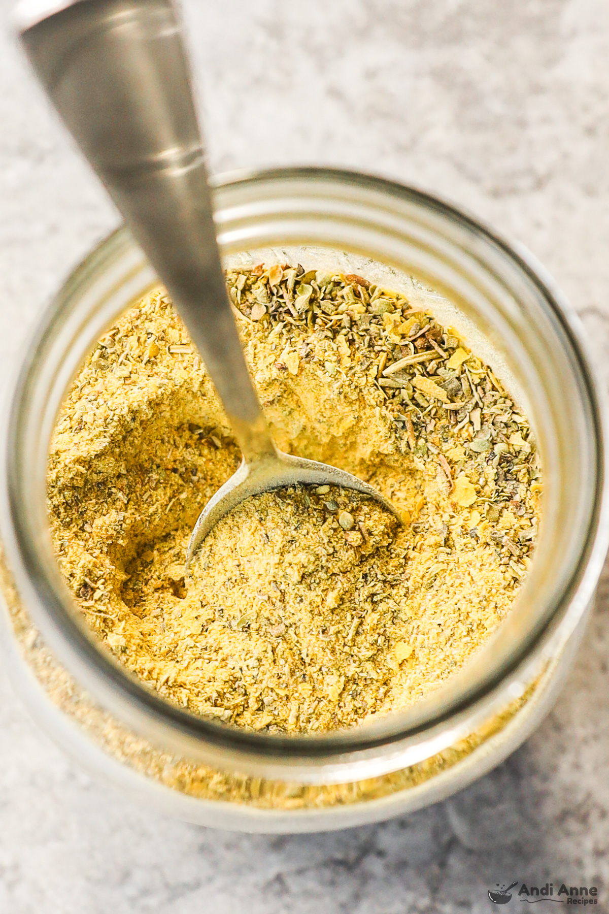 Mason jar with spoon and chicken bouillon powder mixture