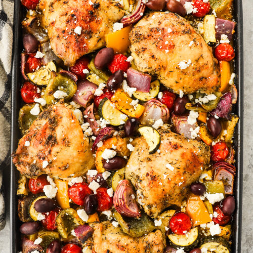 Greek chicken sheet pan dinner all combined on a baking sheet