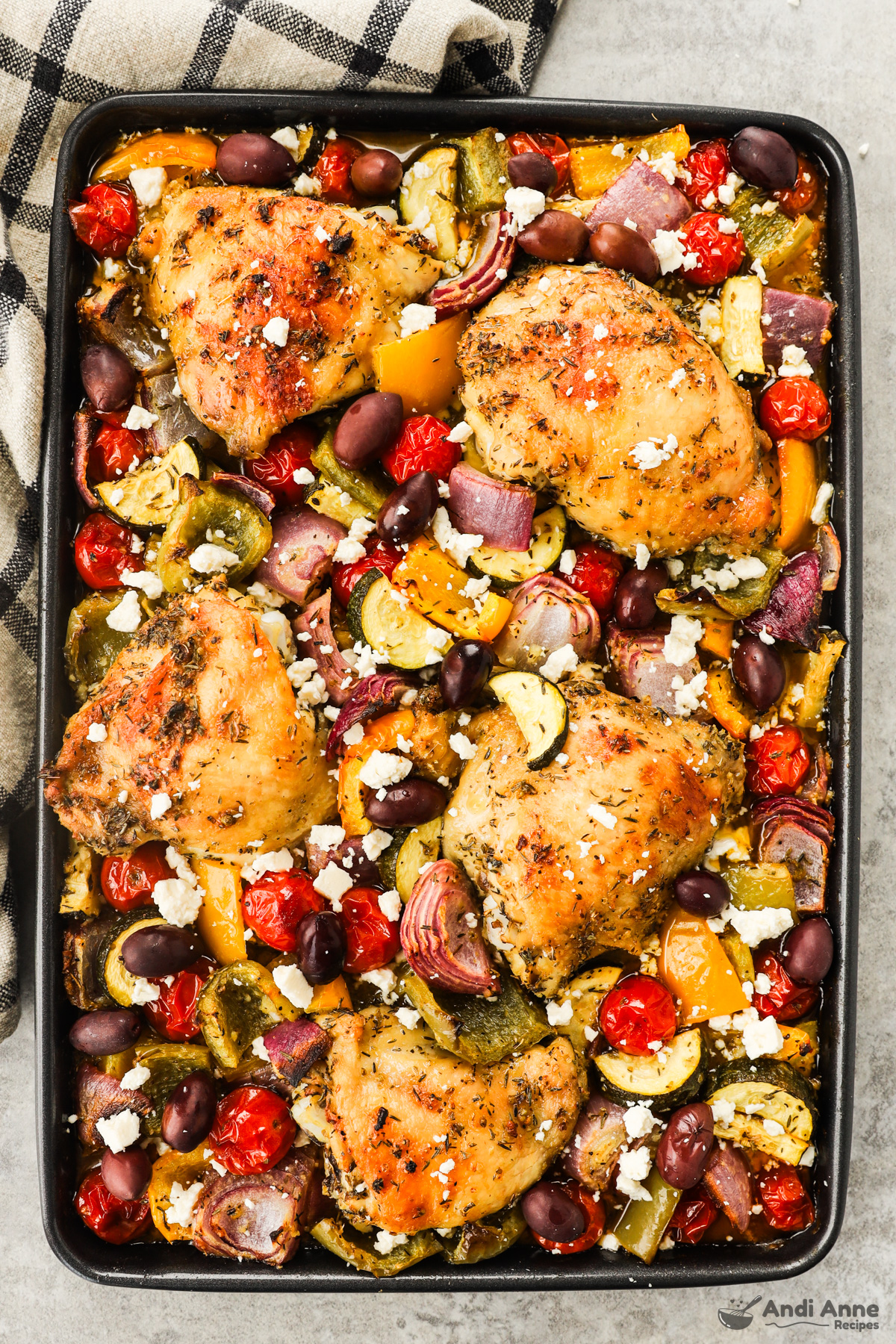 Greek chicken sheet pan dinner all combined on a baking sheet