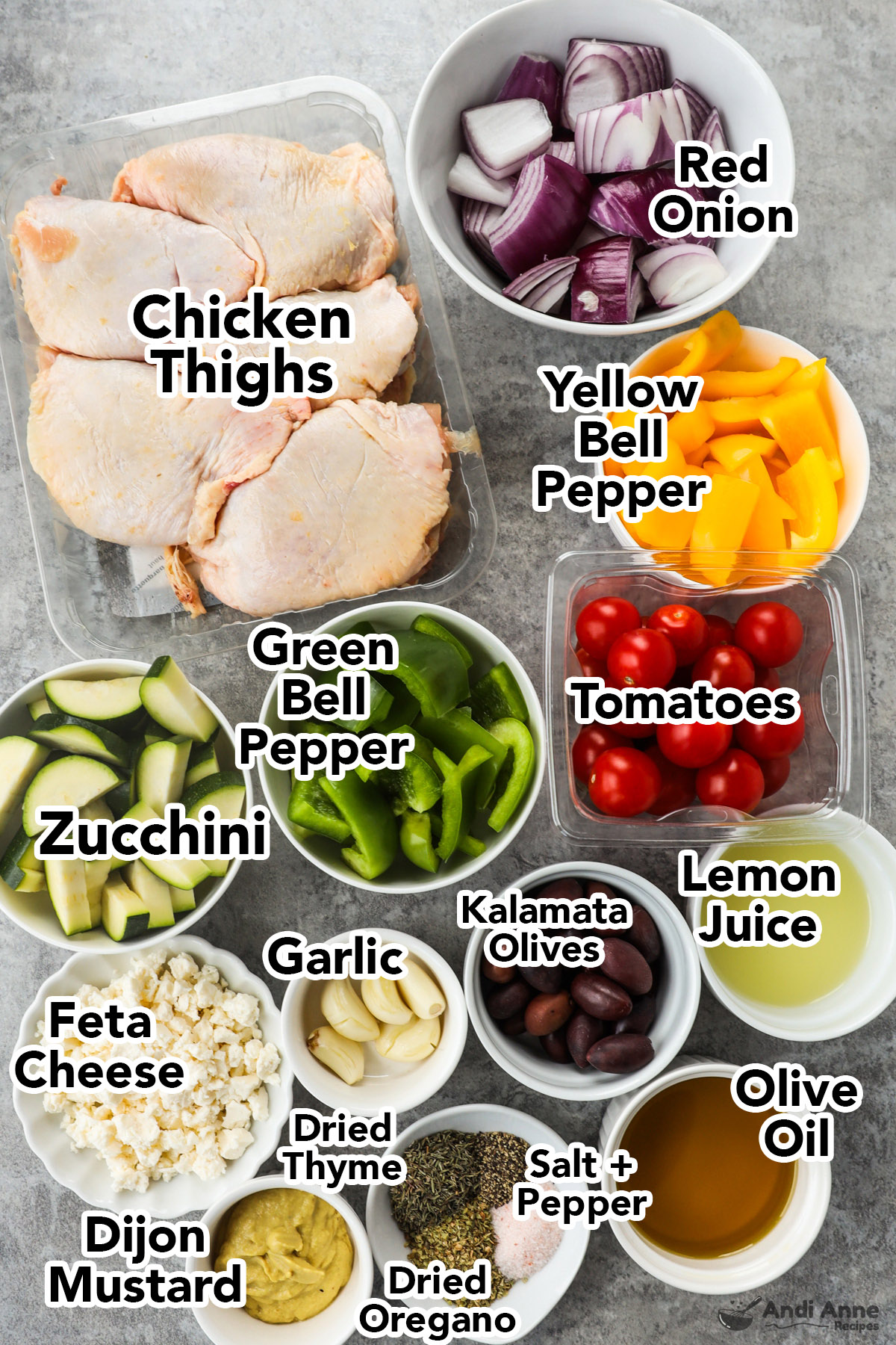 Recipe ingredients including raw chicken thighs, bowls of red onion, bell pepper, tomatoes, zucchini, lemon juice, feta cheese, spices and oil