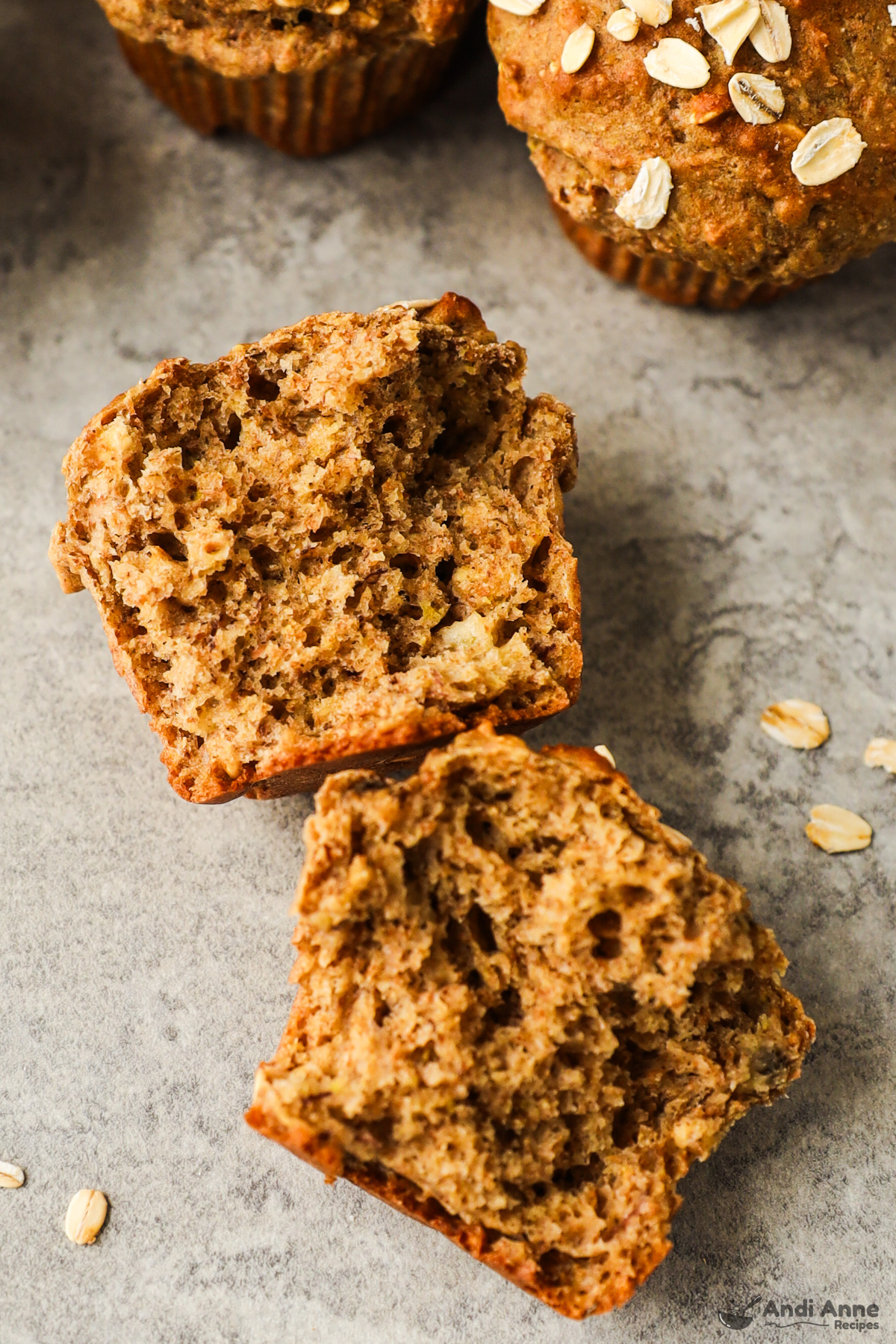 A whole wheat muffin ripped in half with a view of the inside