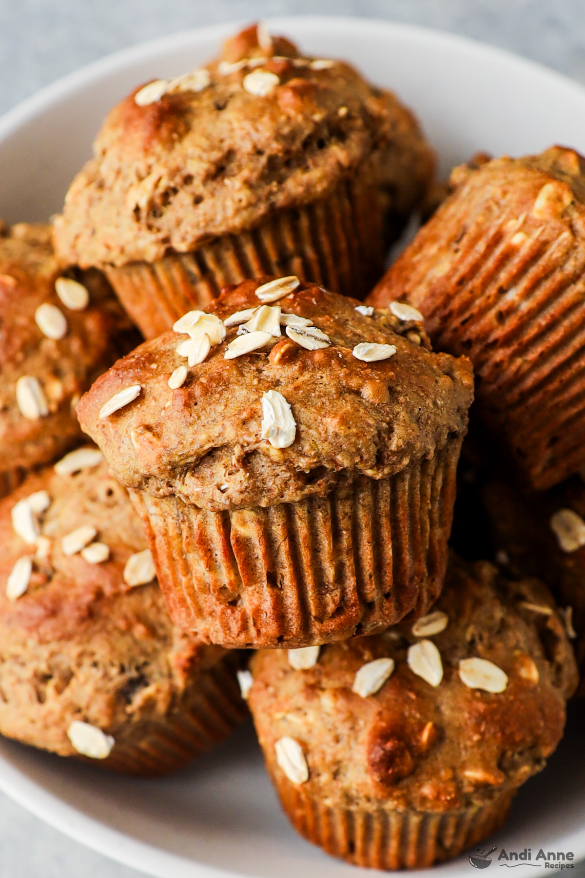 Close up of whole wheat banana muffins piled in a bowl