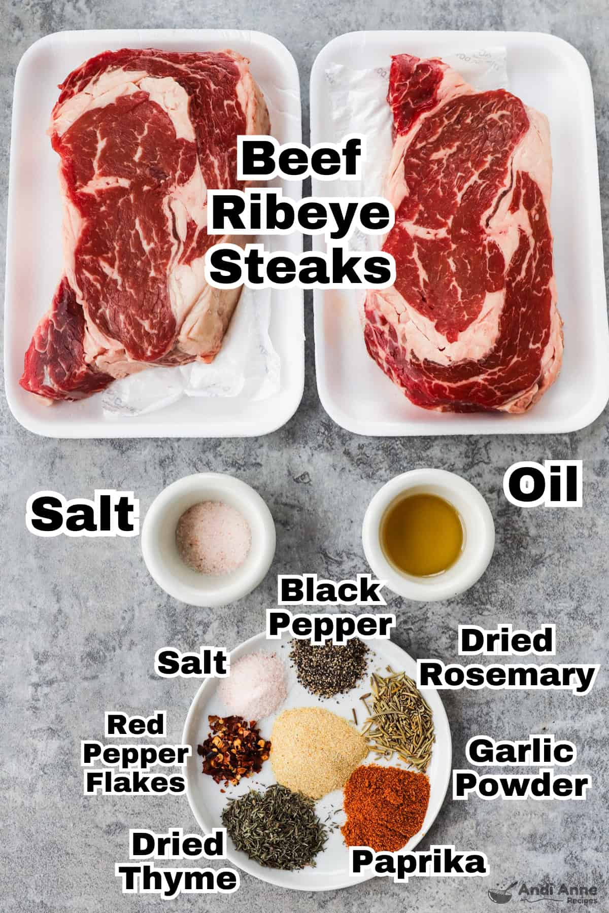 Recipe ingredients including two raw ribeye steaks, bows of salt and oil, and various spices on a plate