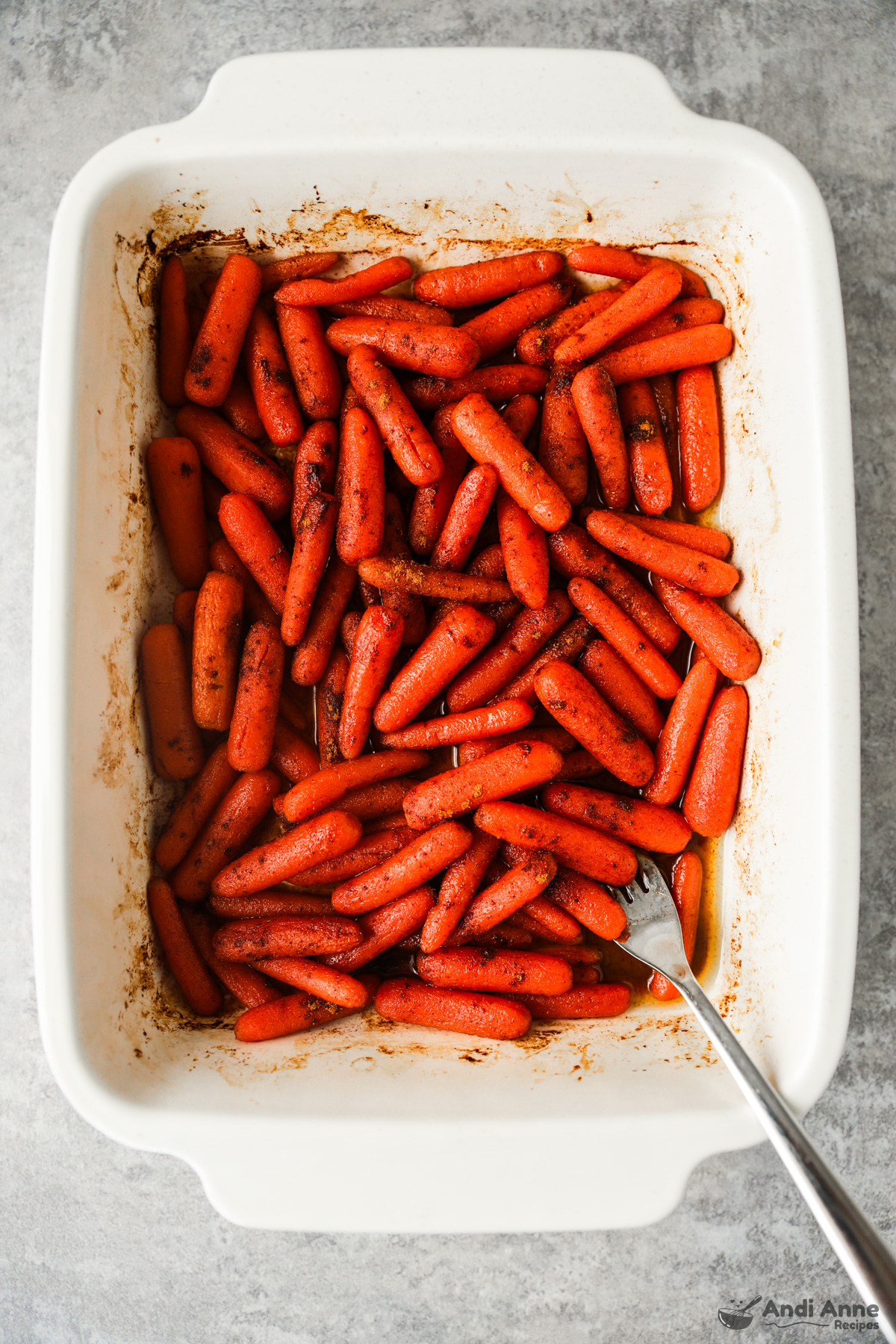 a baking dish with roasted cinnamon honey carrots inside