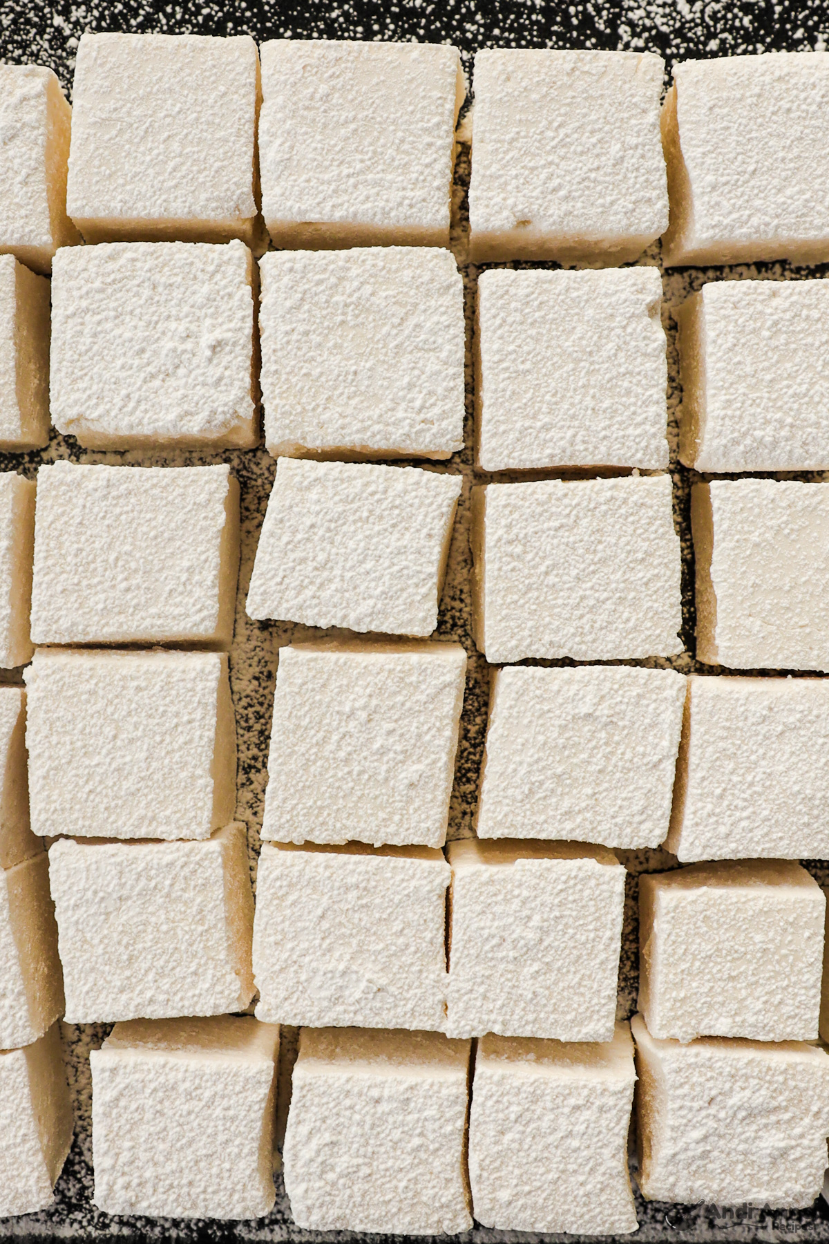 Close up of marshmallow squares dusted with powdered sugar