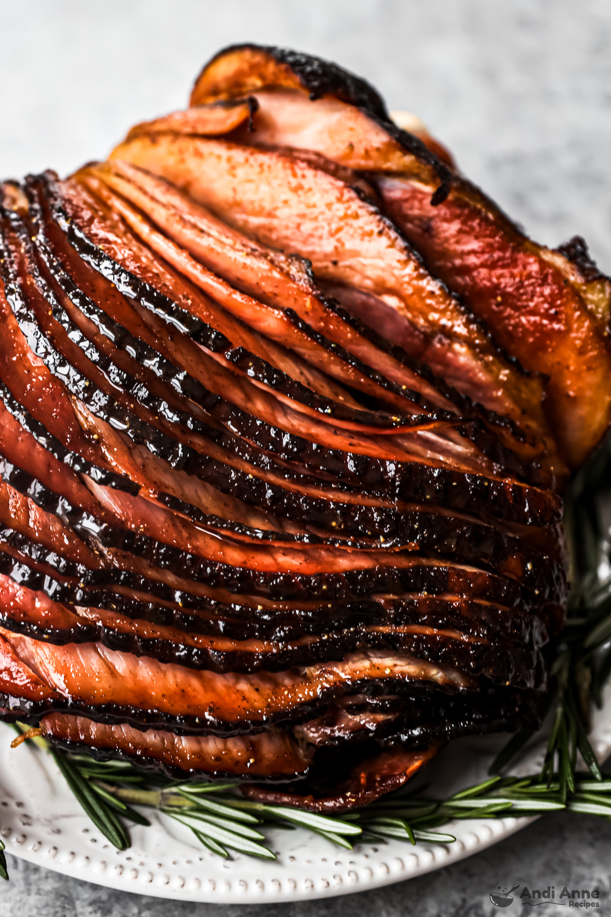 Close up of a cooked spiral ham coated with honey glaze