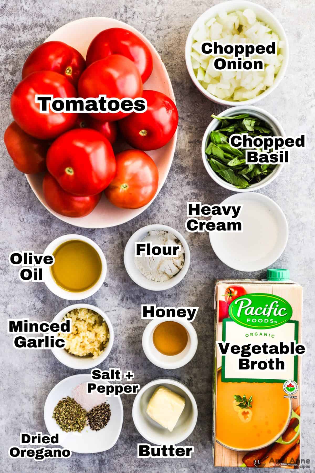 Recipe ingredients in bowls including tomatoes, chopped onion, basil, heavy cream, flour, olive oil, minced garlic, honey, spices and broth