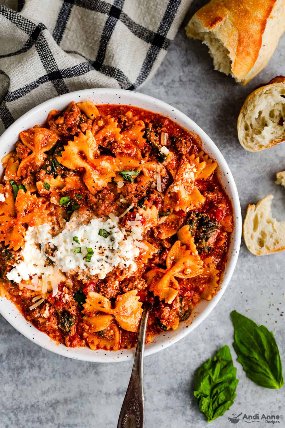 Bowl of lasagna soup topped with a bit of ricotta cheese