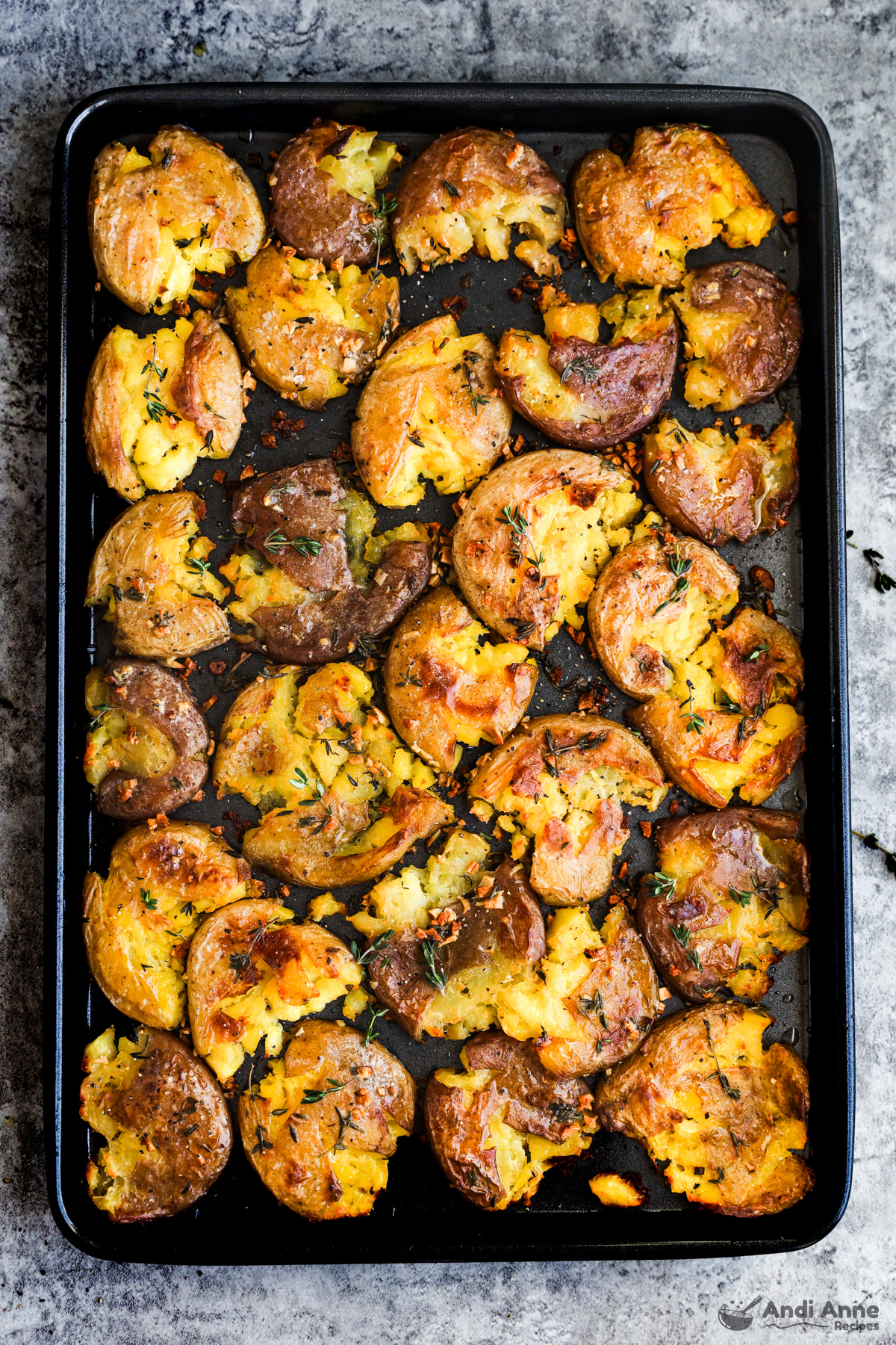 A baking sheet with crispy smashed potatoes 